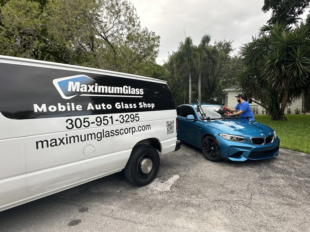 Maximum Glass van parked at a customer's home with the technician preparing the vehicle