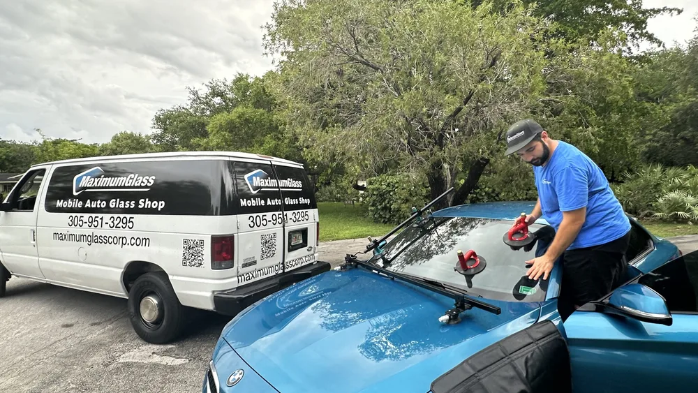 Maximum Glass service van with phone number and QR code parked at a mobile job